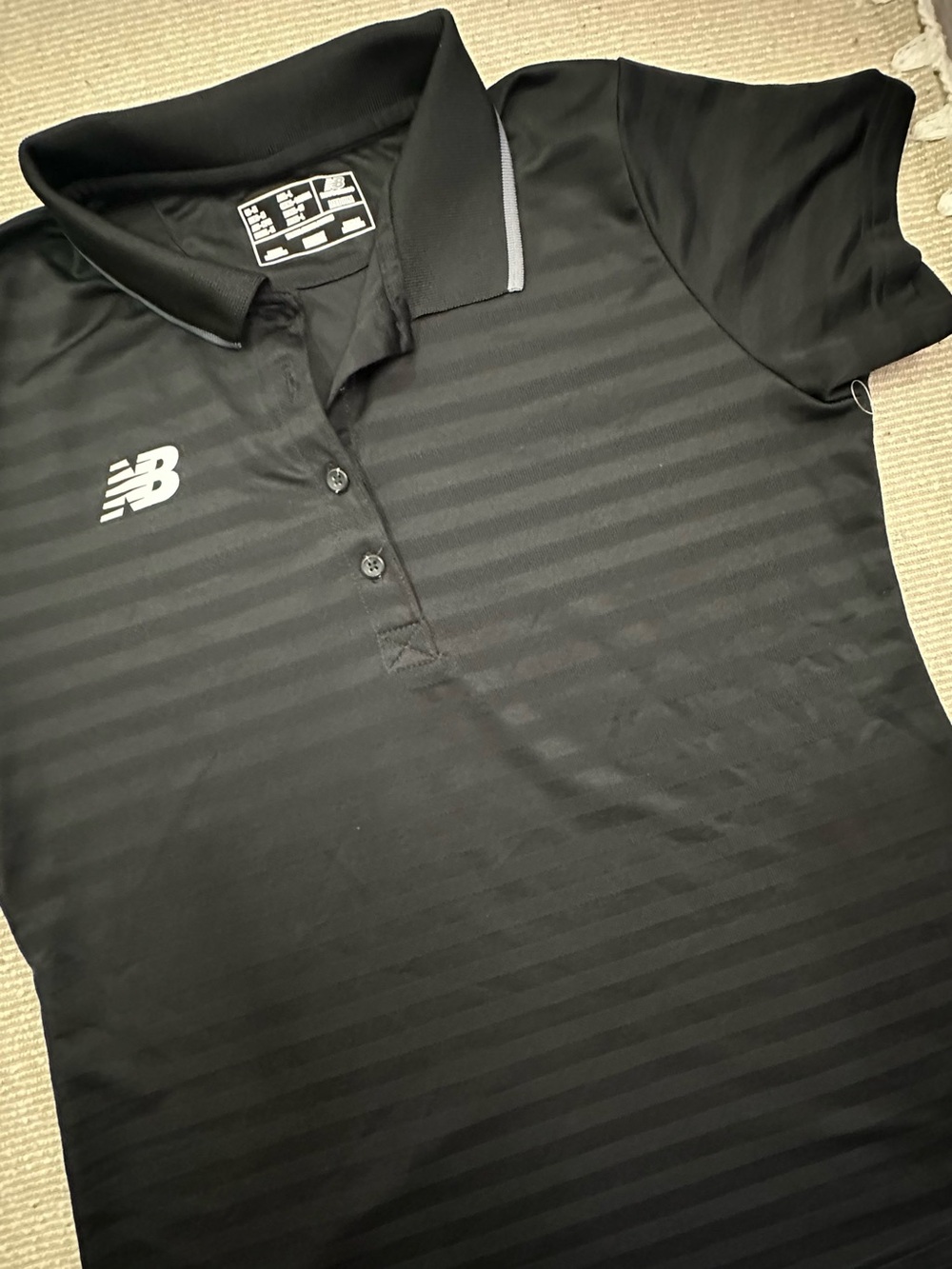 New Balance Black Women's Short-Sleeve Polo with Subtle Stripes